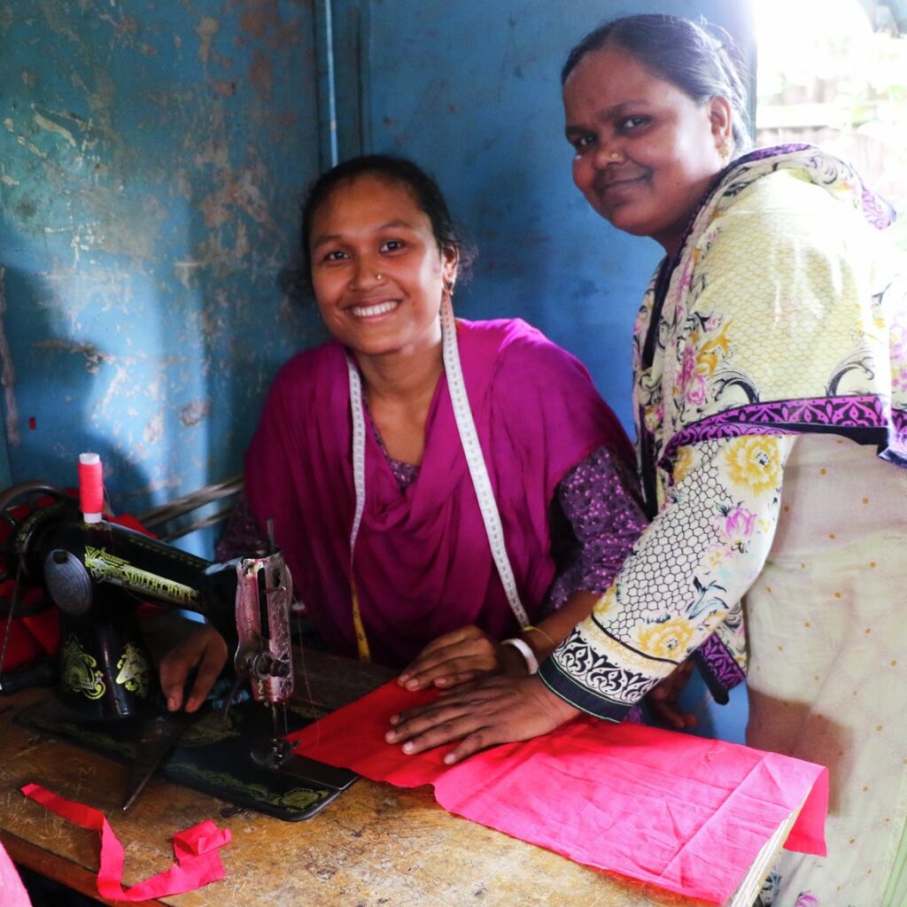 Vocational training for tailors: Two women learning together by a sewing machine